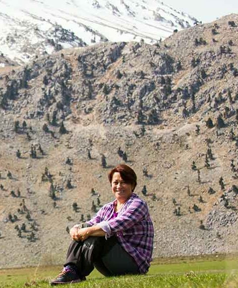 Yasemin Konuralp in the field below a snow-covered Taurus ridge, Antalya, Türkiye.